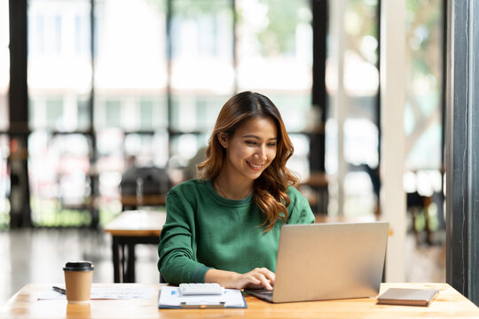 Professional working on a laptop at a desk.