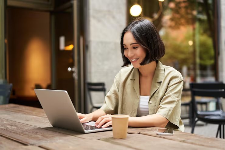 Professional working at a laptop in a café.
